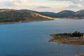 Aerial view of lake with hills on sunset