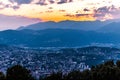 Aerial view of the lake Lugano surrounded by mountains and evening city Lugano on during dramatic sunset, Switzerland, Alps. Royalty Free Stock Photo