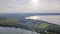 Aerial view of lake and small village on the peninsula. Sunset evening light by calm water on warm beautiful summer day. Royalty Free Stock Photo