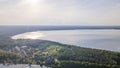Aerial view of lake and small village on the peninsula. Sunset evening light by calm water on warm beautiful summer day Royalty Free Stock Photo