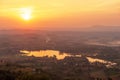 Aerial view of lake with the sun setting over a mountain range Royalty Free Stock Photo