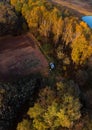 Aerial view of lake at sunrise in autumn. Vertical photo, orange grass, trees at dawn. Colorful aerial landscape of river coast at Royalty Free Stock Photo