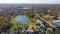 Aerial view lakeside houses with vibrant fall foliage and downtown Dallas, Texas in background, Park Central upscale waterfront Royalty Free Stock Photo