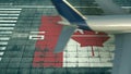 Aerial view of a landing airliner and flag of Canada on the airfield of an airport. Air travel related conceptual 3D