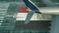 Aerial view of a landing airliner and flag of Egypt on the airfield of an airport. Air travel related conceptual 3D