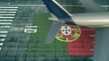 Aerial view of a landing airliner and flag of Portugal on the airfield of an airport. Air travel related conceptual 3D