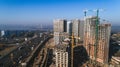 Aerial view of landscape in the city with under construction buildings and industrial cranes. Construction site. Royalty Free Stock Photo