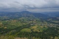 Aerial view of landscape with fields, mountains, woods, and blue sky. natural background. Royalty Free Stock Photo