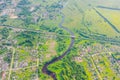 Aerial view landscape of winding small river among the small town railway station and bridge, stream in green field, top view Royalty Free Stock Photo