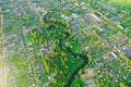 Aerial view landscape of winding small river among the small town, stream in green field Royalty Free Stock Photo