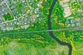 Aerial view landscape of winding small river among the small town, stream in green field, top view meadow Royalty Free Stock Photo