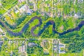 Aerial view landscape of winding small river among the small town, stream in green field, top view meadow Royalty Free Stock Photo