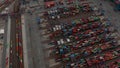 Aerial view of large cargo container terminal in Hamburg with automated cranes sorting through colorful containers
