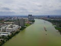 Aerial view of the large cargo ship on the Chao Phraya River with cityscape, The river with green water in rainy season,.