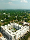 Aerial view of a large contemporary white building with a swimming pool in Kannapolis.