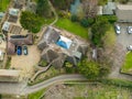 Aerial view of a large, detached bungalow with a large garden and pond.