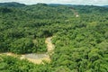 Aerial view of a large and fast flowing tropical river with muddy brown water in a rainforest Royalty Free Stock Photo