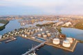 Aerial view of large fuel storage tanks at oil refinery industrial zone in the cargo seaport Royalty Free Stock Photo