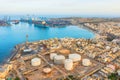 Aerial view of large fuel storage tanks at oil refinery industrial zone in the cargo seaport. Royalty Free Stock Photo