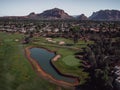 Aerial view of a large golf park in Arizona with rocky mountains in the background