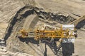 Aerial view of large heavy equipment machine mining natural resource. Coal mining by bucket wheel excavator. Heavy Royalty Free Stock Photo