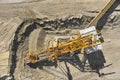 Aerial view of large heavy equipment machine mining natural resource. Coal mining by bucket wheel excavator. Heavy Royalty Free Stock Photo