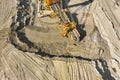 Aerial view of large heavy equipment machine mining natural resource. Coal mining by bucket wheel excavator. Heavy Royalty Free Stock Photo