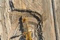 Aerial view of large heavy equipment machine mining natural resource. Coal mining by bucket wheel excavator. Heavy Royalty Free Stock Photo