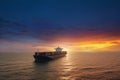 Aerial view of a large, heavy loaded container cargo ship at sunset