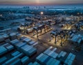 Aerial view of a large illuminated container port at dusk Royalty Free Stock Photo