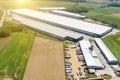 Aerial view of a large logistics warehouse, an online store warehouse, a lot of trucks waiting for loading in the parking lot