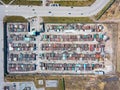 Aerial view of a large number of iron garages for cars with colored roofs standing in close to each other near the road fenced. Royalty Free Stock Photo