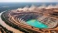 Aerial view of a large openpit mine with a turquoise waterfilled pit and dusty operations Royalty Free Stock Photo