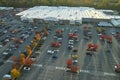 Aerial view of large parking lot in front of rgocery store with many parked colorful cars. Carpark at supercenter Royalty Free Stock Photo