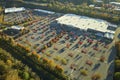 Aerial view of large parking lot in front of rgocery store with many parked colorful cars. Carpark at supercenter Royalty Free Stock Photo