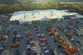 Aerial view of large parking lot in front of rgocery store with many parked colorful cars. Carpark at supercenter Royalty Free Stock Photo