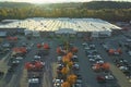 Aerial view of large parking lot in front of rgocery store with many parked colorful cars. Carpark at supercenter Royalty Free Stock Photo