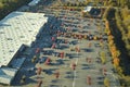 Aerial view of large parking lot in front of rgocery store with many parked colorful cars. Carpark at supercenter Royalty Free Stock Photo