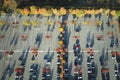 Aerial view of large parking lot with many parked colorful cars. Carpark at supercenter shopping mall with lines and Royalty Free Stock Photo