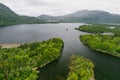 Aerial view of large pine trees on a banks of Muckross Lake, also called Middle Lake or The Torc, located in Killarney National