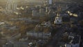 Aerial view of large russian city, buildings, trees, roads with moving cars and church in summer sunny morning. Stock