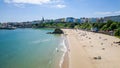 Aerial view of a large sandy beach and colorful buildings behind (Tenby, Wales