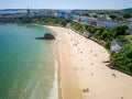 Aerial view of a large sandy beach and colorful buildings behind (Tenby, Wales