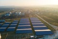 Aerial view of large sustainable electrical power plant with rows of solar photovoltaic panels for producing clean