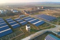 Aerial view of large sustainable electrical power plant with rows of solar photovoltaic panels for producing clean