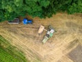 Aerial view of large tractors on a rural farm with lush green fields Royalty Free Stock Photo