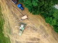 Aerial view of large tractors on a rural farm with lush green fields Royalty Free Stock Photo