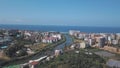 Aerial view of large water channel dividing the city into two parts against blue sky and seashore on the background in