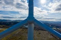 Aerial View of large wind turbine stationary on beautiful welsh landscape. clean energy concept. close up shot of blades Royalty Free Stock Photo