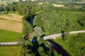 Aerial view of Latvian rural landscape with a winding river, forests and country roads at sunset